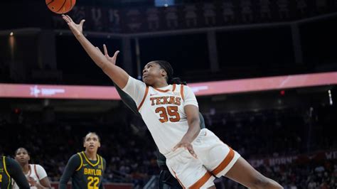 No. 10 Texas hands West Virginia its 1st loss of the season, Booker notches double-double